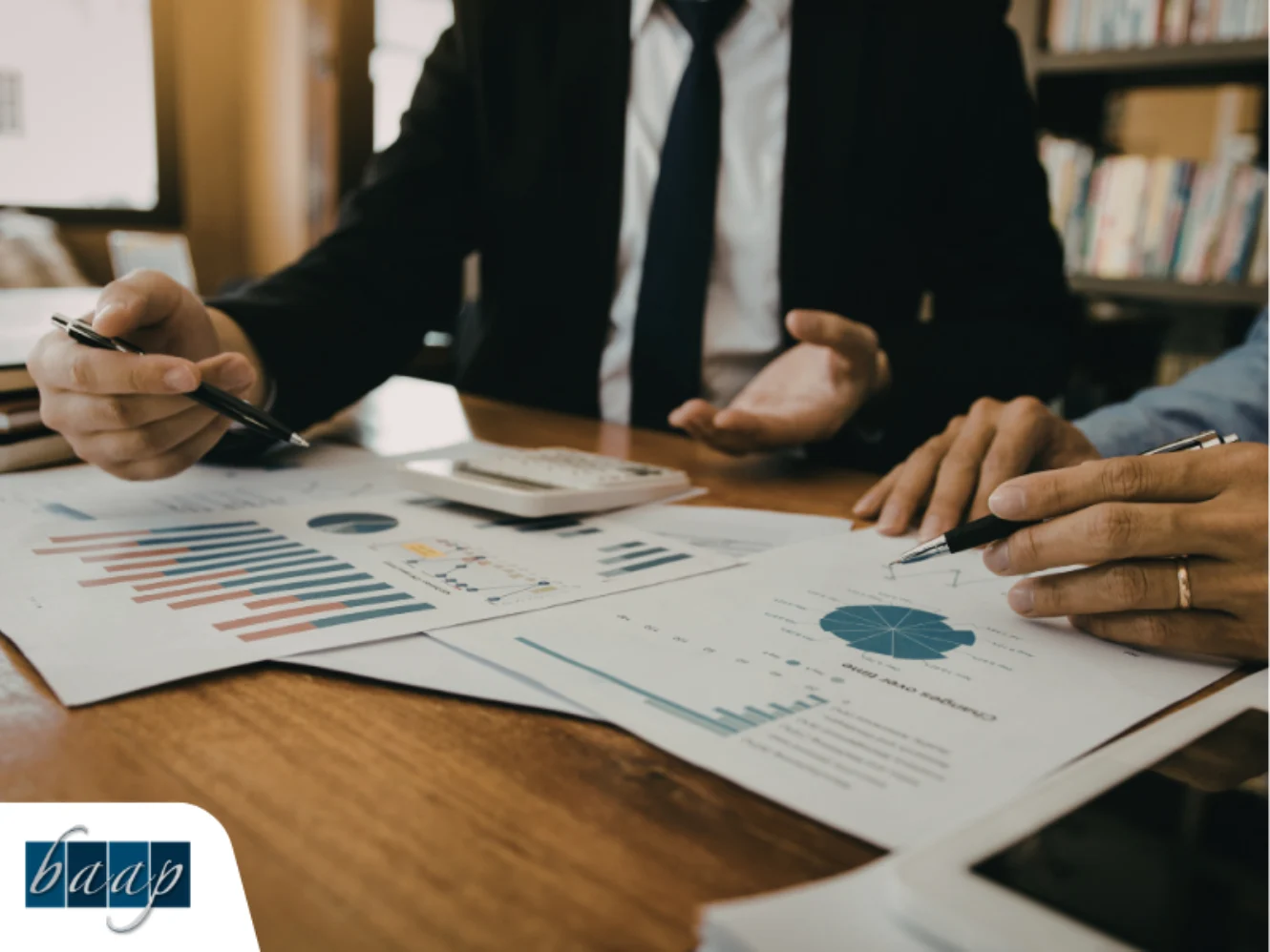 Business professionals reviewing financial charts and reports